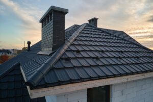 Snow guard for safety in winter on house roof top covered with steel shingles.