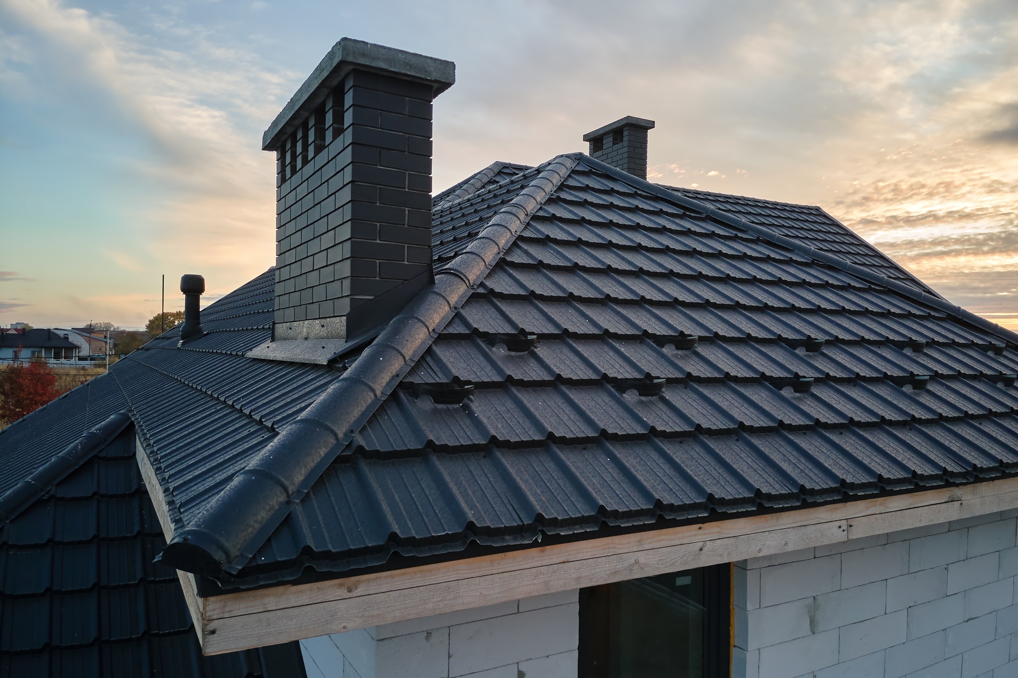 Snow guard for safety in winter on house roof top covered with steel shingles.