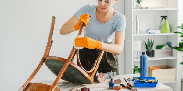 woman-restoring-furniture-using-sandpaper-in-workshop.jpg