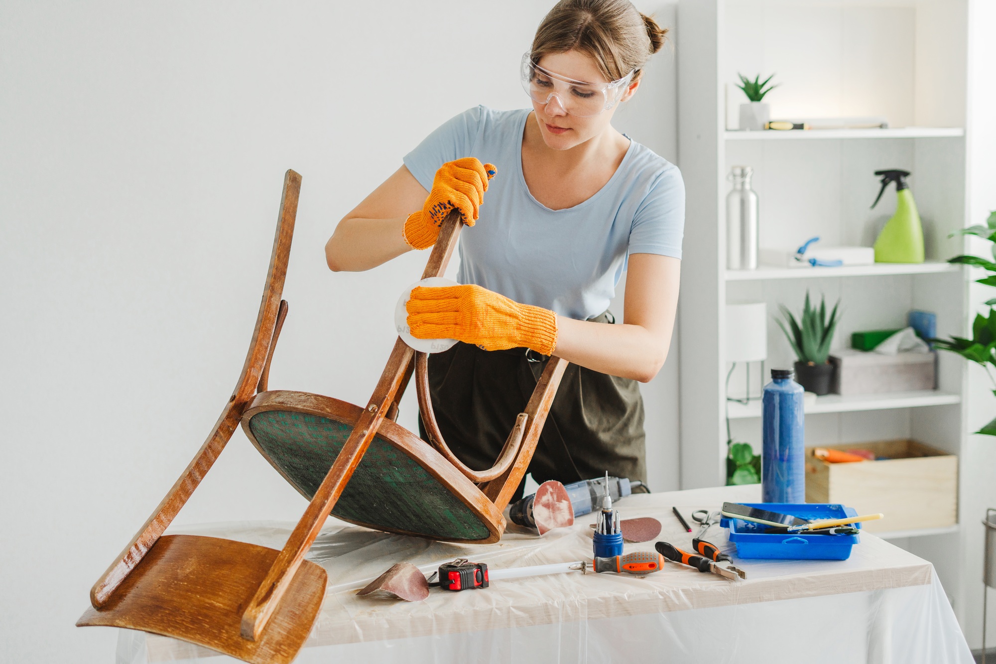 woman-restoring-furniture-using-sandpaper-in-workshop.jpg