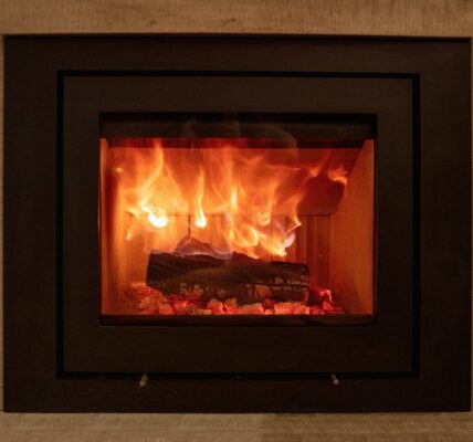 Energy fireplace on a wall, fire flames and burning wood logs in a stove
