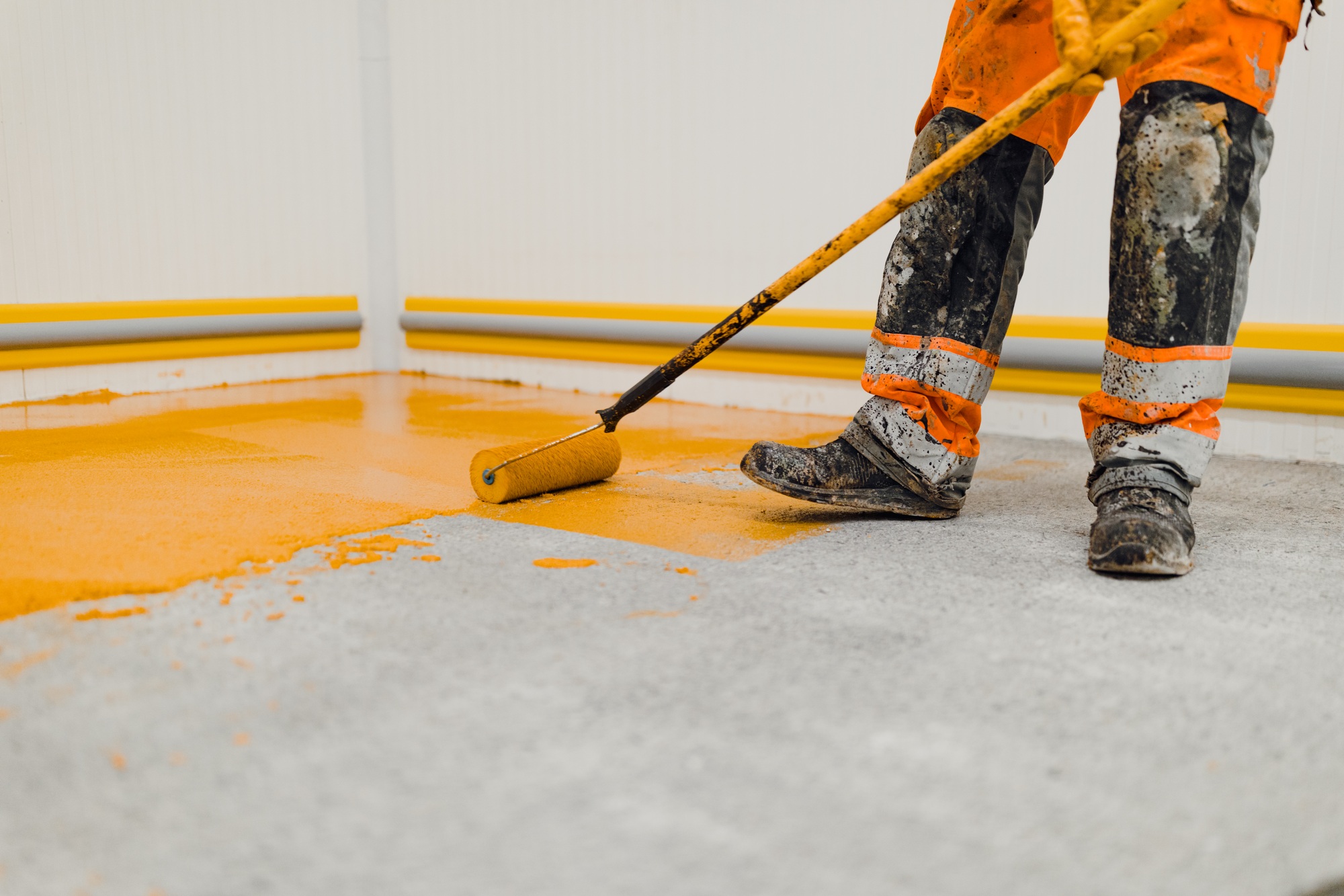 epoxy flooring applicator performs painting works with polyurethane epoxy mortar